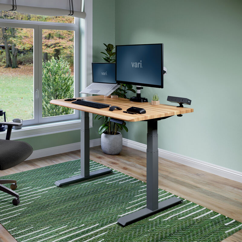 Electric Standing Desk with ComfortEdge in 48x30 Butcher Block in raised position at home image number null